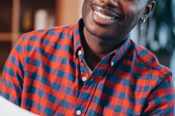 Man closing eyes and smiling in a sunny office environment
